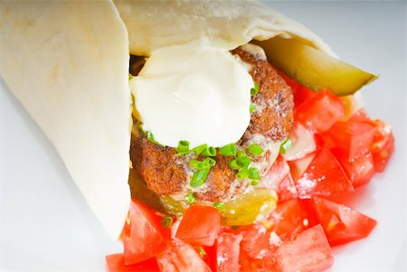 fresh traditional falafel wrap on pita bread with fresh chopped tomatoes Stock Photo - Budget Royalty-Free & Subscription, Code: 400-05264063