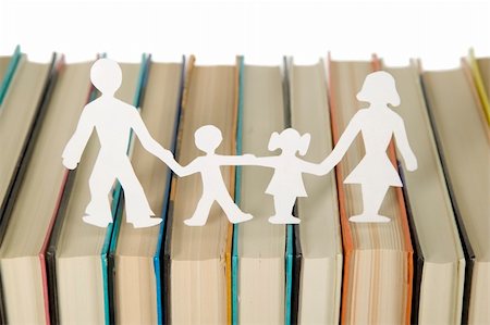 Family figures made from paper with books background, school theme Stockbilder - Microstock & Abonnement, Bildnummer: 400-05264294