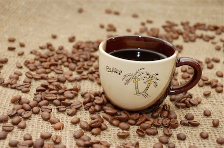 simsearch:400-04604628,k - Cup with coffee. Fried beans at background Stockbilder - Microstock & Abonnement, Bildnummer: 400-05264543