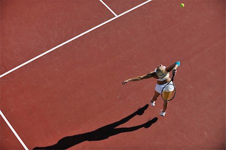 simsearch:400-06061549,k - young fit woman play tennis outdoor on orange tennis field at early morning Photographie de stock - Aubaine LD & Abonnement, Code: 400-05266475