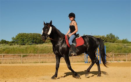 simsearch:400-04256024,k - young girl and her black stallion in a training of dressage Stock Photo - Budget Royalty-Free & Subscription, Code: 400-05266673