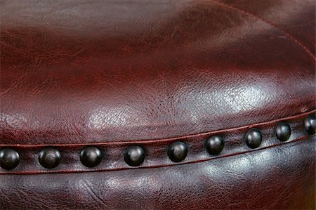 Nail head beading of deep rich chocolate brown leather round ottoman footstool. Fotografie stock - Microstock e Abbonamento, Codice: 400-05266863