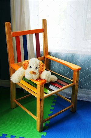 Plush stuffed dog waiting for its kid master in a colorful wood chair in front of a window. Fotografie stock - Microstock e Abbonamento, Codice: 400-05266918