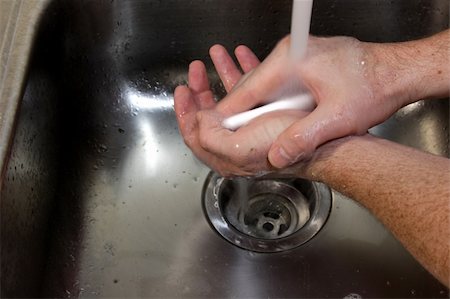 A man washing his hands with soap in a sink. Fotografie stock - Microstock e Abbonamento, Codice: 400-05268104