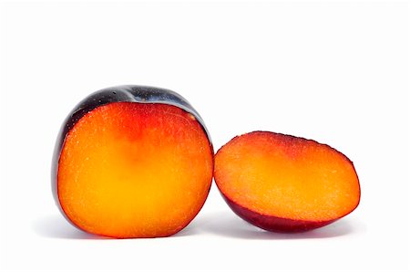 a plum cut in half isolated on a white background Stock Photo - Budget Royalty-Free & Subscription, Code: 400-05268268