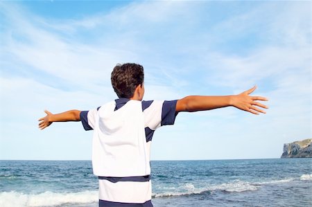 boy teenager open arms rear view looking blue ocean sea beach summer vacation Stock Photo - Budget Royalty-Free & Subscription, Code: 400-05268698