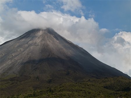Located in Costa Rica the Arenal Volcano sits active under a cloud of steam Stock Photo - Budget Royalty-Free & Subscription, Code: 400-05269577