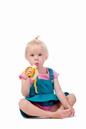 portrait of a little girl with blond hair eating banana - isolated on white Stock Photo - Budget Royalty-Free & Subscription, Code: 400-05269670