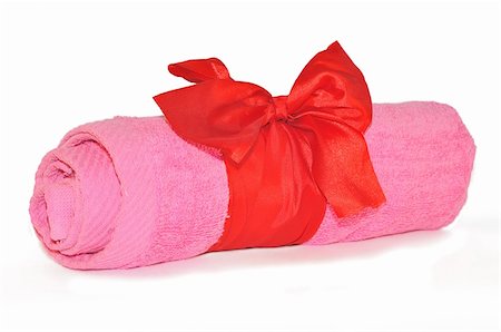 spa towel rolls - Twisted pink towel with red ribbon bow isolated on white Stock Photo - Budget Royalty-Free & Subscription, Code: 400-05269779