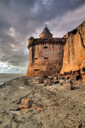 View on the atlantic ocean and church from the beach near Mont Saint-Michel abbey in Brittany, France Stock Photo - Budget Royalty-Free & Subscription, Code: 400-05269827