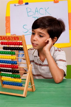 A student solving a math assignment using an abacus Stock Photo - Budget Royalty-Free & Subscription, Code: 400-05260008