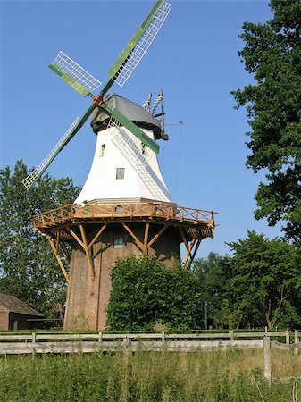 simsearch:400-06101286,k - The old white German windmill with green blades stands among the trees. Stock Photo - Budget Royalty-Free & Subscription, Code: 400-05260218