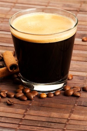 simsearch:400-05260472,k - espresso in a short glass with coffee beans and cinnamon sticks from diagonal top on wooden background Stock Photo - Budget Royalty-Free & Subscription, Code: 400-05260466