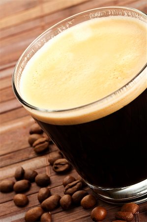 simsearch:400-05260472,k - black espresso coffee in a short glass with coffee beans on wooden background Stock Photo - Budget Royalty-Free & Subscription, Code: 400-05260470