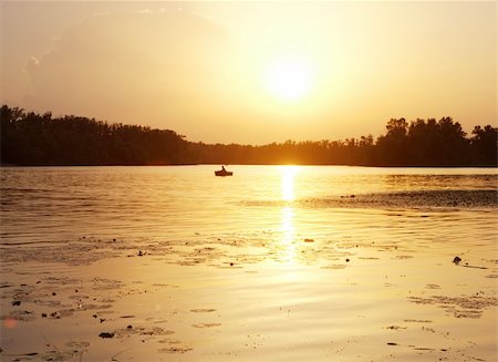 Silhouette of a fisherman on the river at sunset Stock Photo - Budget Royalty-Free & Subscription, Code: 400-05260545