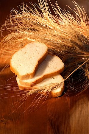 spelt bread - Still life with white sliced bread and ears of wheat on wooden background Stock Photo - Budget Royalty-Free & Subscription, Code: 400-05261003