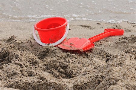 simsearch:640-03259235,k - Red Sand Pail and Shovel on a beach Stock Photo - Budget Royalty-Free & Subscription, Code: 400-05261991