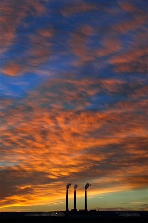 simsearch:400-04430626,k - Three smoke stacks reach above the horizon into a beautiful, vibrant sunrise in the small town of Page in northern Arizona. Photographie de stock - Aubaine LD & Abonnement, Code: 400-05262073