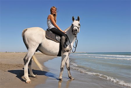 simsearch:400-04660370,k - smiling riding teenager and her white horse on the beach Photographie de stock - Aubaine LD & Abonnement, Code: 400-05262149