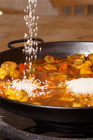 paella pan - Poruing rice into a paella pan, traditional cooking Stock Photo - Budget Royalty-Free & Subscription, Code: 400-05262196