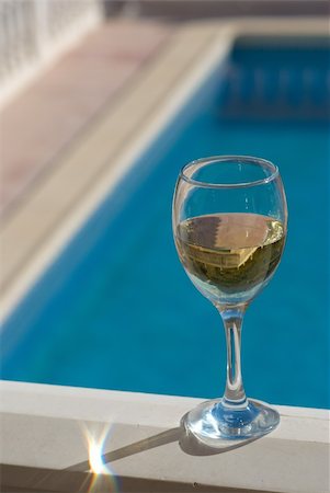A glass of chilled white wine standing next to a pool Stock Photo - Budget Royalty-Free & Subscription, Code: 400-05262198