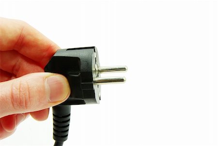 simsearch:400-06093210,k - hand with plug over white background Stock Photo - Budget Royalty-Free & Subscription, Code: 400-05262276