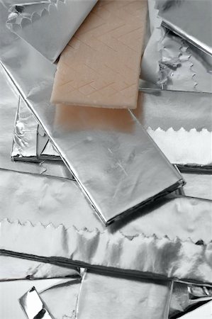 rorem (artist) - several chewing gums packed in wrapping foil, one open, detail vertical photo Foto de stock - Super Valor sin royalties y Suscripción, Código: 400-05262756