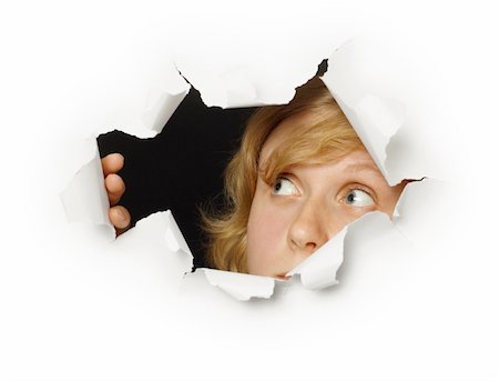 A woman looks out of the hole with curiosity Stock Photo - Budget Royalty-Free & Subscription, Code: 400-05263135