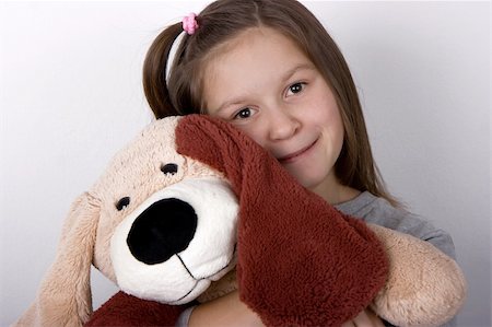 simsearch:400-05352235,k - The happy girl embraces a toy dog Photographie de stock - Aubaine LD & Abonnement, Code: 400-05274309