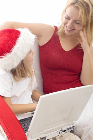 simsearch:400-04712944,k - Woman and little girl playing with a laptop at christmas time - searching for a present online Stock Photo - Budget Royalty-Free & Subscription, Code: 400-05275135