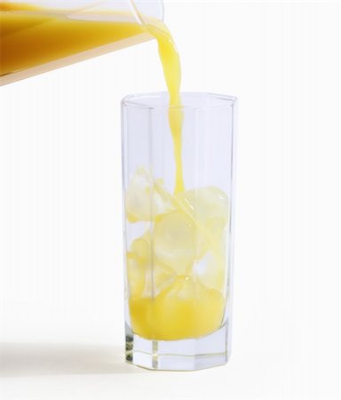 orange juce pouring in a glass on white background  with space for your text  - hand made clipping path included Foto de stock - Royalty-Free Super Valor e Assinatura, Número: 400-05276323