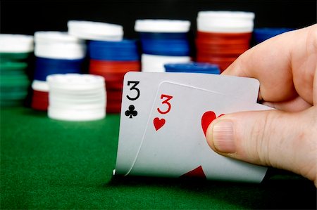 Pair of threes opening hand at Poker (From a series of opening hands at poker) Stock Photo - Budget Royalty-Free & Subscription, Code: 400-05277480