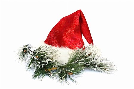simsearch:400-05701397,k - Santa's red hat and fir tree branch isolated on white background. Fotografie stock - Microstock e Abbonamento, Codice: 400-05277517