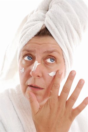 portrait of a mature woman putting moistener on her face Stock Photo - Budget Royalty-Free & Subscription, Code: 400-05277731