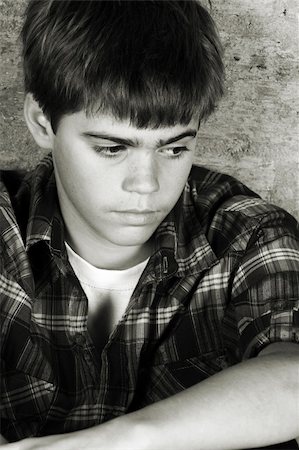 simsearch:400-05284316,k - Serious teenager sitting alone against a brick wall Stockbilder - Microstock & Abonnement, Bildnummer: 400-05278470