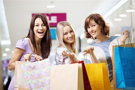 Happy smiling girls in shop with purchases Stock Photo - Budget Royalty-Free & Subscription, Code: 400-05279611