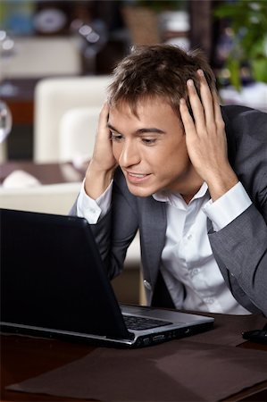 simsearch:400-04322314,k - Business man with the laptop is surprised, looking in the monitor Stock Photo - Budget Royalty-Free & Subscription, Code: 400-05279651