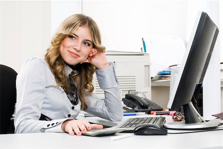 Young business woman sitting in front of computer monitor in office Stock Photo - Budget Royalty-Free & Subscription, Code: 400-05271343