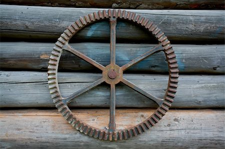 skylight (artist) - Antique farm machinery wheel hanging on old barn log wall Stock Photo - Budget Royalty-Free & Subscription, Code: 400-05271721