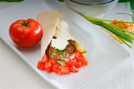 fresh traditional falafel wrap on pita bread with fresh chopped tomatoes Stock Photo - Budget Royalty-Free & Subscription, Code: 400-05272022