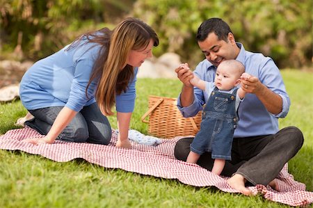 simsearch:400-06062677,k - Happy Mixed Race Family Having a Picnic and Playing In The Park. Photographie de stock - Aubaine LD & Abonnement, Code: 400-05272204