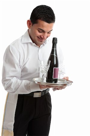 A smiling waiter, bartender, servant or attendant carrying a wine bottle and glasses.  White background. Stock Photo - Budget Royalty-Free & Subscription, Code: 400-05272225