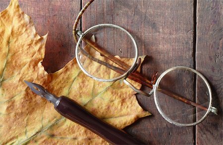 simsearch:400-06772771,k - Vintage still life with dry maple leaf, ink pen and old spectacles lying on wooden background Photographie de stock - Aubaine LD & Abonnement, Code: 400-05273057