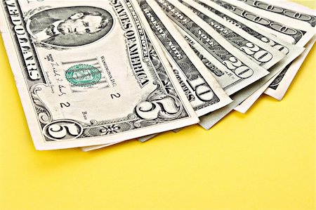 Few dollar banknotes on yellow background Foto de stock - Super Valor sin royalties y Suscripción, Código: 400-05273147