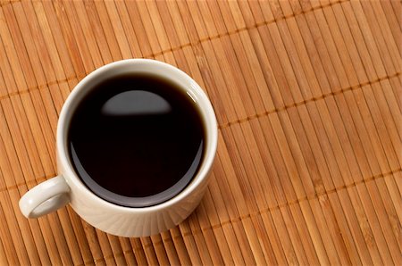 Little white espresso coffee cup on a bamboo mat (upprer view) Stock Photo - Budget Royalty-Free & Subscription, Code: 400-05284090