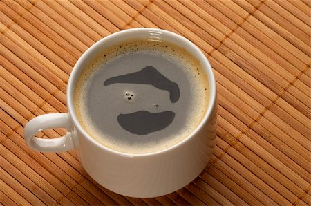 Little white espresso coffee cup on a bamboo mat (upprer view) Fotografie stock - Microstock e Abbonamento, Codice: 400-05284093