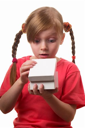 Wondering funny little girl with opened present box isolated over white background Fotografie stock - Microstock e Abbonamento, Codice: 400-05284104