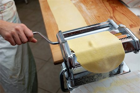 pasta maker - fresh egg pasta rolled in typical italian pasta machine Stock Photo - Budget Royalty-Free & Subscription, Code: 400-05284439