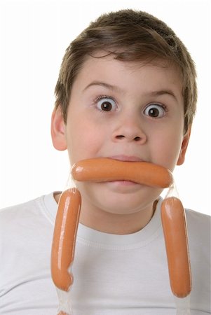 Surprised boy holds sausage in mouth isolated in white Stock Photo - Budget Royalty-Free & Subscription, Code: 400-05284937