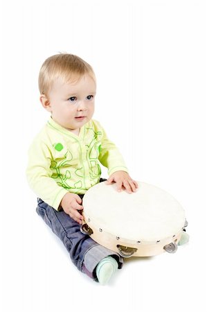 the sitting baby with tambourine on a white isolated background Stock Photo - Budget Royalty-Free & Subscription, Code: 400-05285100